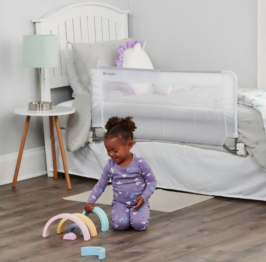 Regalo swing down bed rail on bed with child playing near. Safety guard.