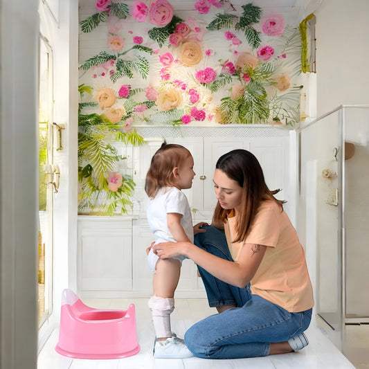 Pink potty training toilet beside child and parent, ready for toilet training.